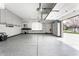 Spacious garage with ample storage, work area, and epoxy flooring for functionality at 7326 Elm Ridge Dr, Indianapolis, IN 46236