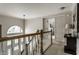 Upstairs hallway featuring a large arched window and decorative lighting fixture at 7326 Elm Ridge Dr, Indianapolis, IN 46236