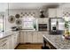 Bright kitchen features granite countertops, stainless steel appliances, and hardwood floors at 7326 Elm Ridge Dr, Indianapolis, IN 46236