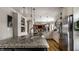 Open-concept kitchen with a large island, granite countertops, stainless steel appliances and hardwood flooring at 7326 Elm Ridge Dr, Indianapolis, IN 46236