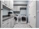 Bright laundry room with white cabinets, gray countertop and modern washer and dryer at 7326 Elm Ridge Dr, Indianapolis, IN 46236