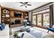 Elegant living room features a brick fireplace, built-in shelves, and stylish furnishings, with a view to the backyard at 7326 Elm Ridge Dr, Indianapolis, IN 46236