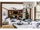 Open-concept living and dining area with hardwood floors, a fireplace, and built-in shelves at 7326 Elm Ridge Dr, Indianapolis, IN 46236