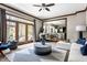 Bright living room with hardwood trim, backyard access, and an open view into the dining room and kitchen at 7326 Elm Ridge Dr, Indianapolis, IN 46236