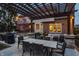 Outdoor patio features stone columns, pergola, dining, cooking, and seating areas, perfect for entertaining at 7326 Elm Ridge Dr, Indianapolis, IN 46236