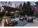 A spacious patio features stone columns, a pergola, and comfortable outdoor seating at 7326 Elm Ridge Dr, Indianapolis, IN 46236