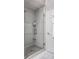 Modern glass enclosed shower with a herringbone tile accent at 7326 Elm Ridge Dr, Indianapolis, IN 46236