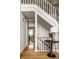 Staircase showcasing hardwood floors and view of a dining area with bright light at 7326 Elm Ridge Dr, Indianapolis, IN 46236