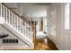 Staircase showcasing hardwood floors and view of a dining area with natural light at 7326 Elm Ridge Dr, Indianapolis, IN 46236