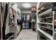 Well-organized walk-in closet with shelving for shoes, handbags, and hanging space for clothing at 7326 Elm Ridge Dr, Indianapolis, IN 46236
