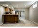 Basement wet bar with wooden countertop, glassware, and wooden cabinetry for entertaining at 7326 Elm Ridge Dr, Indianapolis, IN 46236