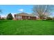 Expansive lawn with a brick house, a view of a patio, and lush landscaping at 803 S School St, Brownsburg, IN 46112
