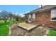 Spacious backyard with a patio, mature trees, and view of the neighbor's yard at 803 S School St, Brownsburg, IN 46112
