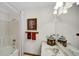 Bright bathroom features a shower-tub combo, vanity sink, and modern lighting at 803 S School St, Brownsburg, IN 46112