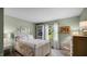 Charming bedroom with a decorative quilt, white furniture, and serene backyard view at 803 S School St, Brownsburg, IN 46112