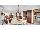 Open dining area with natural lighting, a vintage china cabinet, and views of the adjacent living room at 803 S School St, Brownsburg, IN 46112