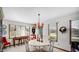 Charming dining area features a round table, chandelier, and natural light from multiple windows at 803 S School St, Brownsburg, IN 46112