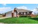 Charming single-Gathering home featuring a brick facade, attached garage and well-maintained lawn at 803 S School St, Brownsburg, IN 46112