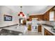 Inviting kitchen with traditional cabinetry, white appliances, a butcher block island, and views into the living room at 803 S School St, Brownsburg, IN 46112
