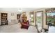 Comfortable living room featuring a brick fireplace, bookshelves, and scenic outdoor views at 803 S School St, Brownsburg, IN 46112