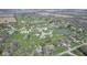 Aerial view of a residential area nestled by a lush green golf course, ponds, and picturesque scenery at 978 S Fairway Village Ct, Greenfield, IN 46140