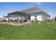 Beautiful backyard featuring a pergola-covered patio, lush green grass, and manicured landscaping at 978 S Fairway Village Ct, Greenfield, IN 46140