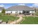 Aerial view of backyard featuring a pergola-covered patio, landscaped garden, and pathway at 978 S Fairway Village Ct, Greenfield, IN 46140