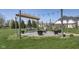 Backyard fire pit featuring a wood pergola, modern chairs and landscaping at 978 S Fairway Village Ct, Greenfield, IN 46140