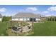 Beautiful backyard with pergola, fire pit, and ample seating for outdoor entertaining on a sunny day at 978 S Fairway Village Ct, Greenfield, IN 46140