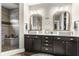 Elegant bathroom showcasing double vanity sinks, framed mirrors, and a tiled walk-in shower at 978 S Fairway Village Ct, Greenfield, IN 46140
