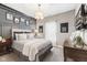 Elegant bedroom featuring gray walls, a large bed, modern furnishings, and cozy decor at 978 S Fairway Village Ct, Greenfield, IN 46140