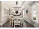 Bright dining room with a tray ceiling, chandelier, and a large window with sheer curtains at 978 S Fairway Village Ct, Greenfield, IN 46140