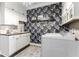 Stylish laundry room with floral wallpaper, white cabinets, and a dark wood countertop at 978 S Fairway Village Ct, Greenfield, IN 46140