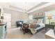 Spacious main bedroom with a chandelier, sitting area, and plenty of natural light at 978 S Fairway Village Ct, Greenfield, IN 46140