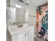 Bright bathroom features a white vanity and floral shower curtain at 106 N Linwood Ave, Indianapolis, IN 46201