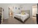 Bedroom with carpet and neutral tones, offering a view of the staircase at 106 N Linwood Ave, Indianapolis, IN 46201
