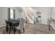 Inviting dining area with sleek flooring, seamlessly connecting to the living room and staircase at 106 N Linwood Ave, Indianapolis, IN 46201
