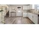 Bright kitchen featuring white cabinets, modern fixtures and sleek flooring, offering a clean and stylish cooking space at 106 N Linwood Ave, Indianapolis, IN 46201