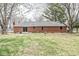 Large backyard showcases a well-maintained lawn, mature trees, and a classic brick home, perfect for outdoor living at 1132 Sheffield Dr, Avon, IN 46123