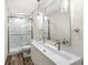 Modern bathroom with double sink, updated vanity, and walk-in shower with glass door at 1132 Sheffield Dr, Avon, IN 46123