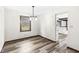 Dining room with modern chandelier, hardwood floors, and adjacent view of the kitchen at 1132 Sheffield Dr, Avon, IN 46123