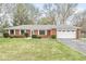 Charming brick ranch-style home with a well-maintained lawn and attached two car garage at 1132 Sheffield Dr, Avon, IN 46123