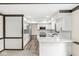 Bright, open kitchen featuring white cabinets, stainless steel appliances, and hardwood floors at 1132 Sheffield Dr, Avon, IN 46123