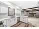 Modern kitchen with white cabinets, stainless steel appliances, and an open view of the living area at 1132 Sheffield Dr, Avon, IN 46123