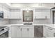 Modern kitchen featuring white cabinets, stainless steel appliances, and quartz countertops at 1132 Sheffield Dr, Avon, IN 46123