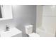 Bathroom features white toilet, white sink with vanity and tub with white tiled wall at 1139 Topp Creek Dr, Indianapolis, IN 46214
