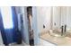 Modern bathroom with clear glass sink, granite countertop, stylish blue curtains and closet at 1139 Topp Creek Dr, Indianapolis, IN 46214