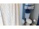 Cozy bathroom featuring stylish shower curtain and convenient shelving unit for storage and organization at 1139 Topp Creek Dr, Indianapolis, IN 46214