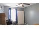 Bright bedroom with a ceiling fan, large window with blue curtains, and space for furnishings at 1139 Topp Creek Dr, Indianapolis, IN 46214