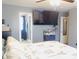 Bedroom with a ceiling fan, large TV, and doorway leading to additional spaces in the house at 1139 Topp Creek Dr, Indianapolis, IN 46214